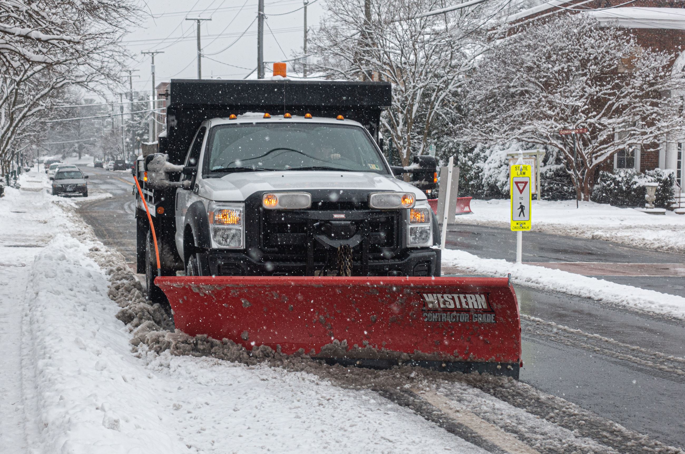 Silver truck plowing snow 